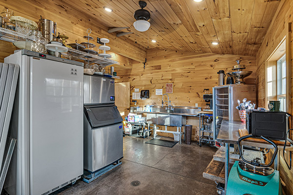 Prep kitchen with icemaker, heating cabinet, refrigeration, coffee maker and all manner of serving utensils and dishes